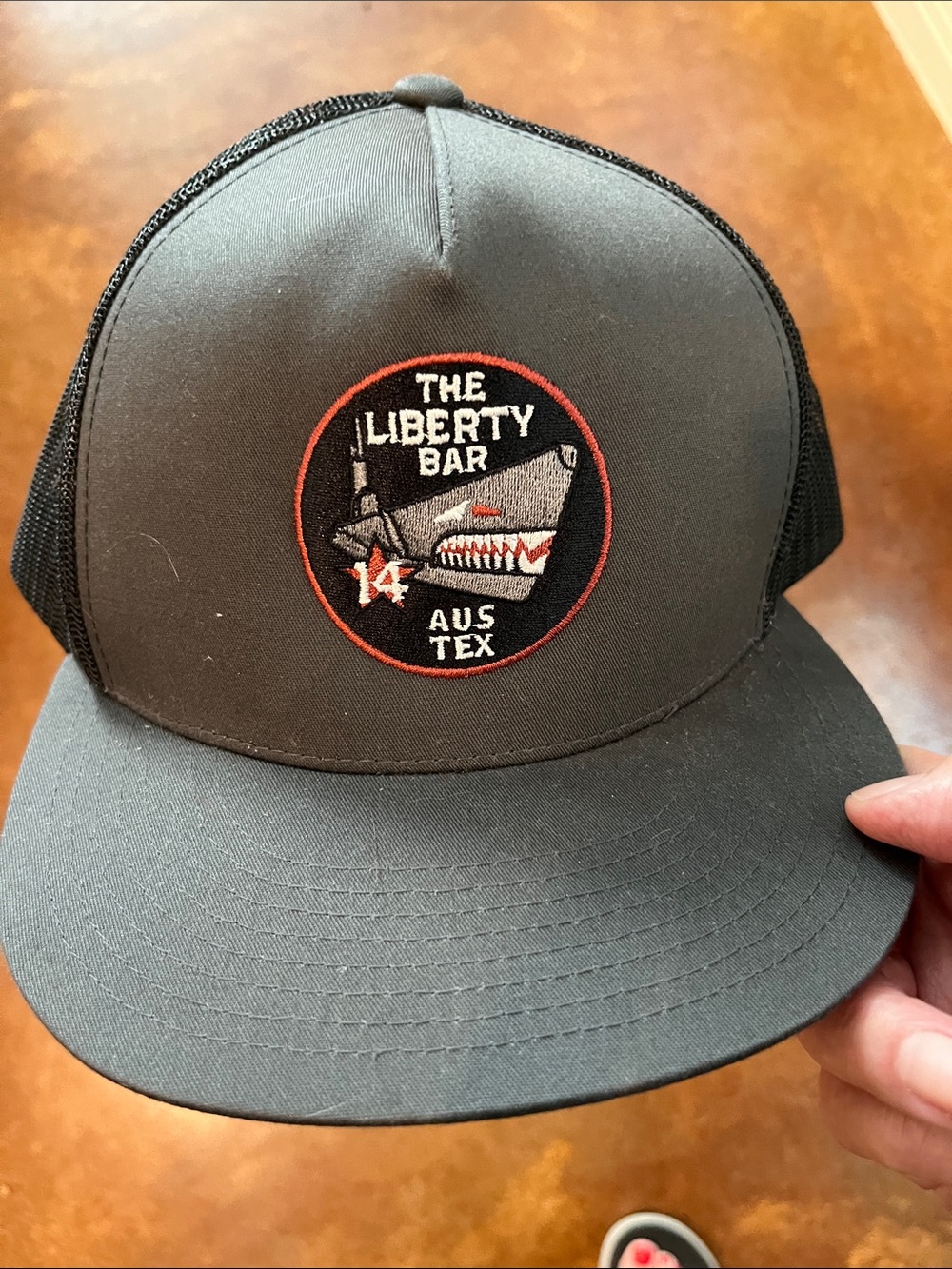 The Liberty Bar Black Trucker Cap with Embroidered Patch